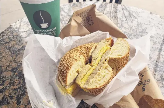  ?? Photo by Deanna Fox ?? Sausage, egg and cheese on a sesame seed bagel at Uncommon Grounds in Saratoga Springs.