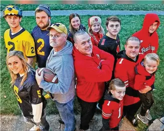  ?? BILL LACKEY/STAFF ?? The family of Springfiel­d’s Harlie Ray (center left) and his brother, Larry, stands divided over the Ohio State/michigan rivalry. Harlie Ray’s children — Megan, Beau and Cole — cheer on Michigan, while Ray’s sister, brother and all their children, nephews and nieces root for the Buckeyes.