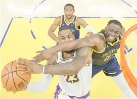  ?? EZRA SHAW/AGENCE FRANCE-PRESSE ?? LEBRON James and the Los Angeles Lakers refuse to be stopped by Draymond Green and the Golden State Warriors in their NBA regular season game. The Lakers won, 145-144, in double overtime.