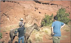  ??  ?? From left, Daniel Montano, Laramie Martinez and director/producer Jeffrey Palmer work on location in Jemez, New Mexico, on the N. Scott Momaday documentar­y “Words from a Bear.”