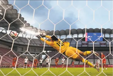  ?? Naomi Baker / Getty Images ?? United States goalkeeper Adrianna Franch, who came on to replace injured starter Alyssa Naeher, can’t get to Jessie Fleming’s penalty kick for Canada, which came in the 75th minute of the semifinal game.