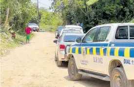  ?? ANDRÉ WILLIAMS ?? Police vehicles on the scene in Burnside Valley, Red Hills, St Andrew, where two men were shot and killed yesterday.