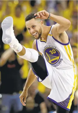  ?? MARCIO JOSE SANCHEZ/ASSOCIATED PRESS ?? Stephen Curry high-steps after scoring against the Cleveland Cavaliers on Thursday during the second half of Game 1 of the NBA Finals in Oakland. Curry finished with 28 points.