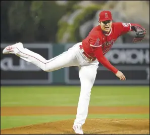  ?? Associated Press ?? MODERN-DAY BABE RUTH — Angels starting pitcher Shohei Ohtani throws to the plate during the fifth inning against the Tampa Bay Rays on Wednesday in Anaheim. Ohtani is the first pitcher since Babe Ruth to start a game as the MLB home run leader.