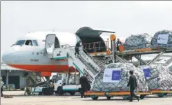  ?? YANG XIAOXUAN / FOR CHINA DAILY ?? Goods are loaded onto a plane, which will head for Moscow, at Hangzhou Xiaoshan Internatio­nal Airport. The trans-continenta­l air freight route, under the operation of Cainiao Network Technology Co Ltd, has been in service since March 29.