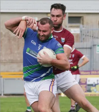  ??  ?? Craig Doyle of Glynn-Barntown is challenged by St. Martin’s midfielder Daithí Waters.