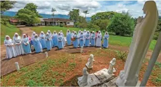  ??  ?? Fellow nuns of Maria Valentina de los Angeles make their morning prayer at a convent.