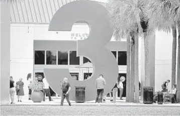  ?? SUSAN STOCKER/SOUTH FLORIDA SUN SENTINEL ?? Shoppers wait to enter the Sawgrass Mills Mall in Sunrise on Monday, the mall’s first day of reopening.