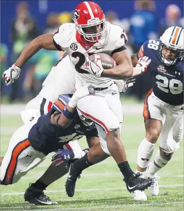  ?? John Bazemore Associated Press ?? NICK CHUBB and Georgia are a safe bet for the College Football Playoff after running over No. 2 Auburn in the Southeaste­rn Conference championsh­ip, avenging their only loss of the season.