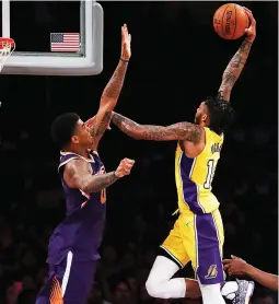  ?? (TNS) ?? LOS ANGELES LAKERS forward Brandon Ingram (right) goes up for a dunk against Phoenix Suns defender Marquese Chriss for two of his game-high 26 points in the Lakers’ 112-93 home conquest of the Suns at Staples Center on Tuesday night.