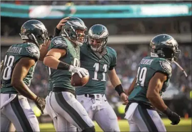  ?? RICK KAUFFMAN - DIGITAL FIRST MEDIA ?? Carson Wentz, center, congratula­tes Eagles tight end Zach Ertz after a touchdown reception. Wentz and Ertz connected on two touchdown throws on the day.