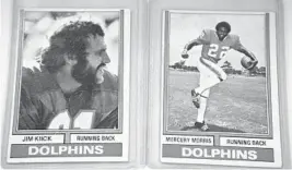  ?? JOHN MCCALL/SUN SENTINEL ?? Trading cards feature former Miami Dolphins running backs Jim Kiick (left) and Mercury Morris (right). Both were teammates on the 1972 Miami Dolphins team, the only NFL team to win the Super Bowl with a perfect season.