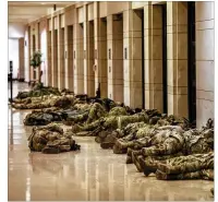  ??  ?? National Guard troops deployed to the U.S. Capitol, sleep inside of the visitors center after their shift, Thursday. An official estimated Wednesday more than 20,000 National Guardsmen would be active in D.C. on Inaugurati­on Day.