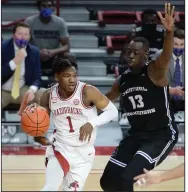  ?? (NWA Democrat-Gazette/Andy Shupe) ?? Arkansas guard JD Notae (1) drives the baseline Saturday while being guarded by UCA forward Eddy Kayouloud during the Razorbacks’ victory over the Bears. Notae finished with a game-high 22 points.