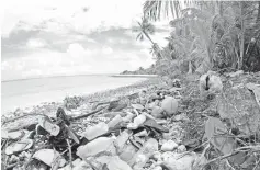  ??  ?? Photo shows debris on a beach on Cocos Islands. — AFP photo