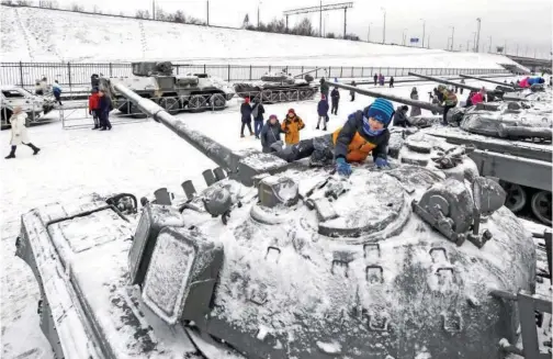  ?? Associated Press ?? ↑ People have a closer look at tanks at an exhibition at the museum in Kirovsk, Russia, on Sunday.