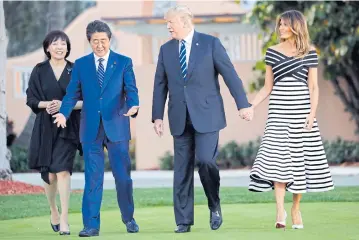  ?? AP ?? President Trump, first lady Melania, Japanese Prime Minister Shinzo Abe and his wife Akie Abe take a walk in Florida on Tuesday.