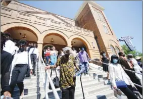  ?? (AP/Jay Reeves) ?? Crowd members exit 16th Street Baptist Church Thursday in Birmingham after a service marking the 59th anniversar­y of the bombing.