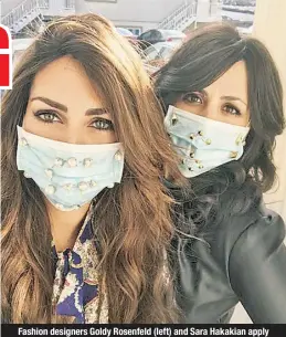  ??  ?? Fashion designers Goldy Rosenfeld (left) and Sara Hakakian apply adhesive jewels to bling out their medical masks.