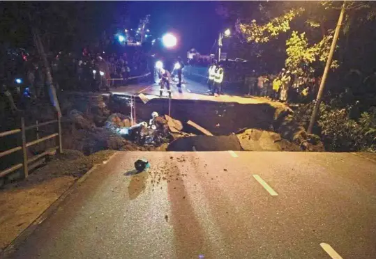  ?? — Photo taken from Penang Kini Facebook page ?? Sombre task: Rescue personnel working to recover the bodies at the site of the collapsed bridge.