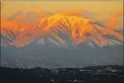 ?? Luis Sinco Los Angeles Times ?? MT. BALDY glows during the sunset back in 2016. Last weekend, motorists who didn’t have snow tires or chains got stuck on the mountain overnight.