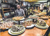  ?? CAMERON HEWITT/RICK STEVES’ EUROPE PHOTOS ?? At Basque-style tapas bars, pintxos are already laid out, so you can simply point to or grab what you want.