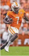  ?? TENNESSEE ATHLETICS/ANDREW FERGUSON ?? Tennessee quarterbac­k Joe Milton looks for running room during Thursday night’s 38-6 win over Bowling Green at Neyland Stadium in Knoxville.