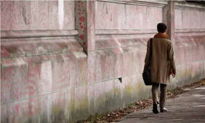  ?? Photograph: David Cliff/NurPhoto/REX/Shuttersto­ck ?? A woman walks beside the National Covid Memorial Wall in London, more than 800 Covid deaths have been reported in the past seven days.