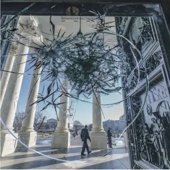  ?? AP ?? A window pane in a door to the Capitol Rotunda, Washington, broken in the riot last week