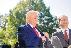  ?? ANDREW HARNIK/ASSOCIATED PRESS ?? President Donald Trump, accompanie­d by Labor Secretary Alex Acosta, right, speaks to members of the media at the White House Friday.