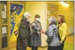  ?? ?? Gov. Michelle Lujan Grisham and Taos Municipal Schools superinten­dent Lillian Torrez (right) meet with Tewa language teachers at Enos Garcia.