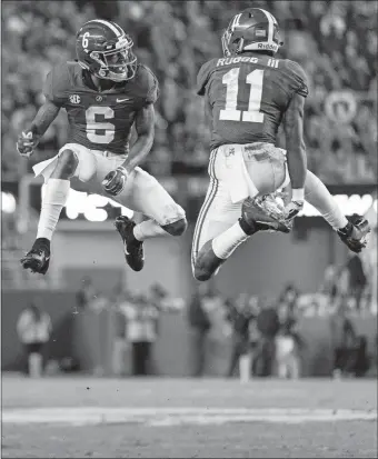  ?? VASHA HUNT/AP PHOTO ?? Alabama wide receivers DeVonta Smith (6) and Henry Ruggs III (11) celebrate a touchdown reception by Ruggs during the No. 1 Crimson Tide’s 52-21 win over Auburn on Saturday in Tuscaloosa, Ala.