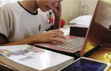  ?? ?? A World Bank study revealed that the Philippine’s internet connectivi­ty “lags in affordabil­ity, speed and access.” Photo shows a student taking part in their online classes inside their home in Parañaque.