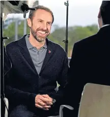  ?? ?? Gareth Southgate chats to journalist­s