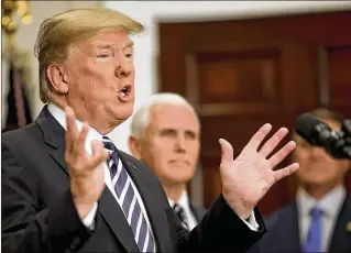  ?? WIN MCNAMEE / GETTY IMAGES ?? President Donald Trump was upset Thursday after Kim Jong Un’s aide called VP Mike Pence (rear) a “political dummy” for remarks about the late Libyan leader Moammar Gadhafi’s demise.