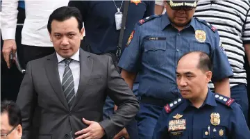  ?? — AFP photo ?? Trillanes (left) leaves a police station after posting bail.