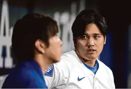  ?? Lee Jin-man/Associated Press ?? Los Angeles Dodgers’ Shohei Ohtani, right, chats with his interprete­r Ippei Mizuhara during an exhibition game against Team Korea on Monday at the Gocheok Sky Dome in Seoul, South Korea.