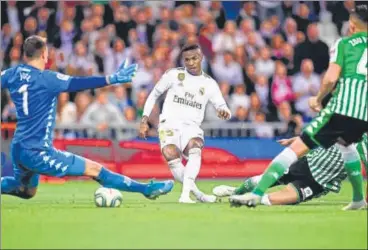  ?? AFP ?? Real Madrid's Brazilian forward Vinicius Junior (C) tries to score past Real Betis goalkeeper Joel Robles during their La liga match.