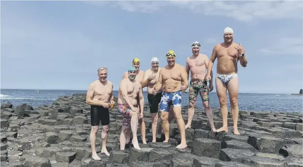  ??  ?? 0 From left, Adrian Poucher (support crew), Dominic Mudge, Keith Garry, John Mcelroy, Bill Donnelly, Colin Lindsay and Chris Judge on the Giant’s Causeway after completing their swim from Islay