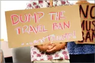  ?? AP PHOTO BY CALEB JONES ?? In this June 30, 2017, file photo, critics of President Donald Trump’s travel ban hold signs during a news conference in Honolulu.
