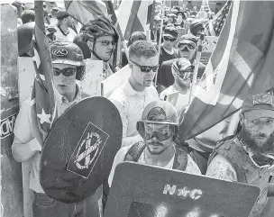  ??  ?? White nationalis­ts and counterpro­testers clash during Saturday’s rally in Charlottes­ville, Va. The American Civil Liberties Union went to court last week in defense of white nationalis­ts’ right to hold the rally, which turned violent and crystalliz­ed a...