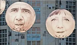  ?? JENS MEYER/AP ?? Activists fly balloons of President Barack Obama and German Chancellor Angela Merkel prior to the G-7 summit, which is seen as a chance for them to strengthen their bond.