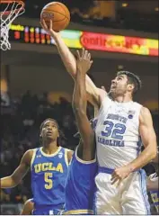  ?? Chase Stevens Associated Press ?? NORTH CAROLINA’S Luke Maye (32) scores two of his 16 points as UCLA’s Cody Riley defends.