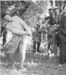  ?? ?? Jack Burke Jr. hits from under a dogwood tree along the 15th fairway during the final round of the 1956 Masters.