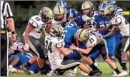  ?? / Steven Eckhoff ?? Pepperell’s Jack Bennett (34) and Jimmy Powell (23) bring down Model’s Kidron Ford early in the two teams’ Region 7-AA battle.