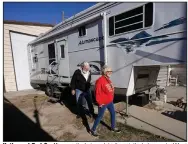  ??  ?? Kathy and Bud Scott pass their travel trailer at their home in West Valley, Utah, earlier this month. They say they still plan to make their annual trip to Arizona after Christmas, but with extra precaution­s. (AP/Rick Bowmer)