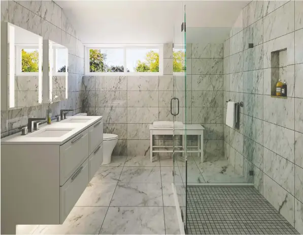  ??  ?? The spacious bathroom has a light and airy feel with a frameless glass shower enclosure.