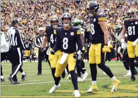  ?? AP PHOTO/DON WRIGHT ?? Pittsburgh Steelers quarterbac­k Kenny Pickett (8) celebrates beside teammates after scoring a touchdown against the New York Jets during the second half of an NFL football game, Sunday, Oct. 2, 2022, in Pittsburgh.