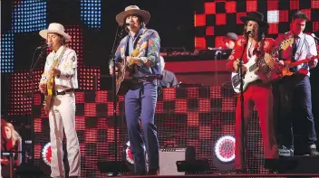  ?? WADE PAYNE/THE ASSOCIATED PRESS/FILES ?? Midland’s Jess Carson, left, Mark Wystrach and Cameron Duddy perform their first single, Drinkin’ Problem, at the CMT Music Awards in Nashville earlier this year.