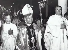  ?? PACIFIC DAILY NEWS ?? Tomas Camacho leaves his ordination ceremony in 1985. He has sought to dismiss lawsuits accusing him of sexual abuse.